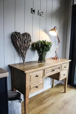 a wooden desk with a lamp and two plants on it at Fawns Rest in Nantmel