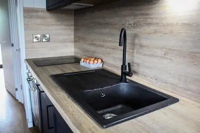 a kitchen with a black sink and a counter at Fawns Rest in Nantmel