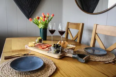 a table with two glasses of wine and a tray of food at Fawns Rest in Nantmel
