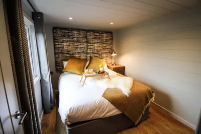 a bedroom with a bed with a brick wall at Buck Barn in Nantmel