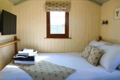 a bedroom with a large white bed with a window at Mayflower in Rhayader