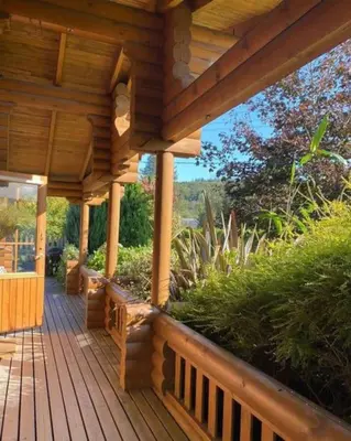 a wooden porch of a wooden house at Beautiful 2 Bedroom Log Cabin With Private Hot Tub - Elm in Leominster