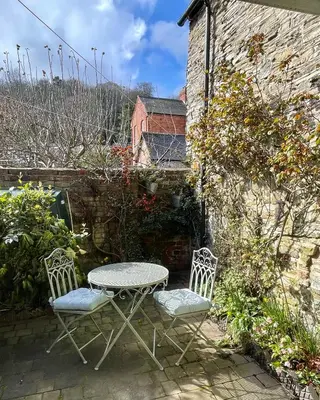 two chairs and a table and a table and chairs at Hurdley House-Georgian Town House in Montgomery