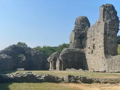 an old stone building with an arch in a field at Hurdley House-Georgian Town House in Montgomery