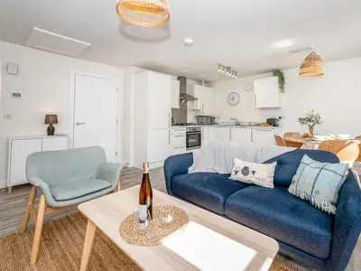 a living room with a blue couch and a table at Brand new 1 bedroom modern contemporary apartment - Pass the Keys in Ludlow