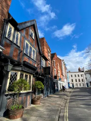 a cobblestone street in a town with buildings at Superbly Located Handsome Georgian Townhouse - Pass the Keys in Shrewsbury
