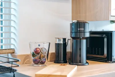 a coffee maker on a counter next to a microwave at Quaint Georgian house with Parking & Huge Garden 10 mins walk from town in Shrewsbury