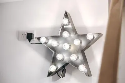 a silver star with lights on a wall at Quaint Georgian house with Parking & Huge Garden 10 mins walk from town in Shrewsbury