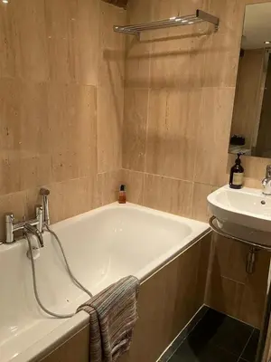 a bathroom with a bath tub and a sink at Hay On Wye Welsh Townhouse in Hay centre in Hay-on-Wye