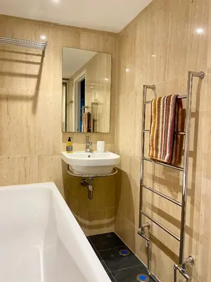 a bathroom with a sink and a bath tub and a sink at Hay On Wye Welsh Townhouse in Hay centre in Hay-on-Wye