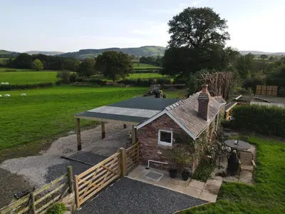 an overhead view of a small house in a field at Romantic country cabin with log burner, spectacular views, spa hot tub - Brecon Beacons National Park dog friendly in Llangadog