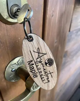 a key chain with a padlock on a door at Romantic Log Cabin With Hot Tub in Leominster