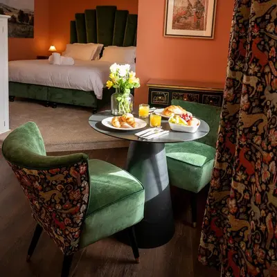 a hotel room with a table with a plate of food at The Fanny Talbot in Barmouth