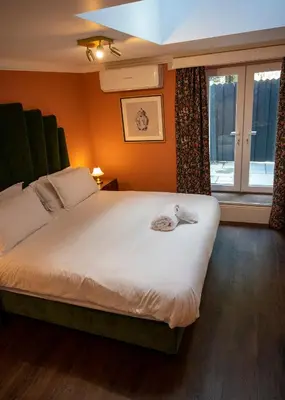 a bedroom with a large bed and a window at The Fanny Talbot in Barmouth