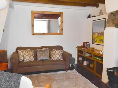a living room with a couch and a mirror at Tryfar House in Harlech