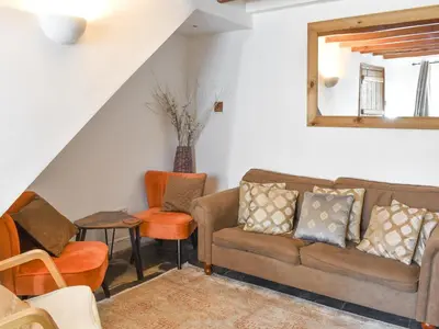 a living room with a couch and chairs at Tryfar House in Harlech