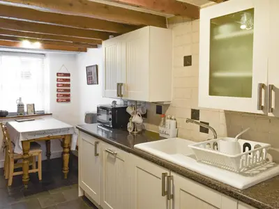 a kitchen with a sink and a counter top at Tryfar House in Harlech