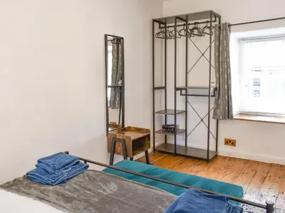 a room with a bed and a mirror at Tryfar House in Harlech