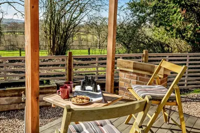 a table and chairs on a porch with a tea set at 1 Bed in Builth Wells oc-p27441 in Builth Road