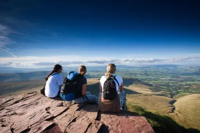 three people sitting on the top of a mountain at 1 Bed in Builth Wells oc-p27441 in Builth Road
