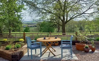 a wooden table and two chairs sitting around a table at 1 Bed in Builth Wells oc-p27441 in Builth Road
