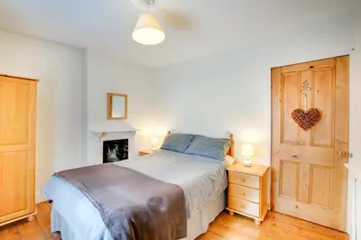 a bedroom with a bed and a wooden door at 2 Bed in Dolgellau oc-wah671 in Dolgellau