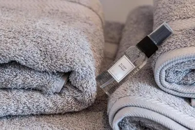 a bottle of soap sitting on top of a bed at Seagrass Cottage - Aberdovey in Aberdyfi