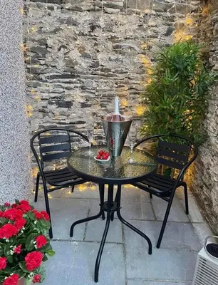 a table and two chairs on a patio at Seagrass Cottage - Aberdovey in Aberdyfi
