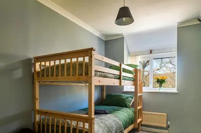 a bedroom with two bunk beds and a window at Finest Retreats - Felin Ship in Dolgellau
