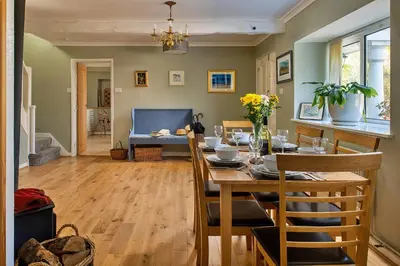 a dining room with a table and chairs in a room at Finest Retreats - Felin Ship in Dolgellau
