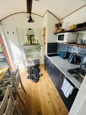 a kitchen with a sink and a counter top at Romantic Shepherds Hut with Hot Tub in The Heart of Snowdonia in Dolgellau