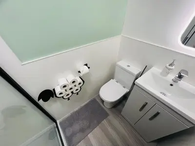 a small bathroom with a toilet and a sink at Romantic Shepherds Hut with Hot Tub in The Heart of Snowdonia in Dolgellau
