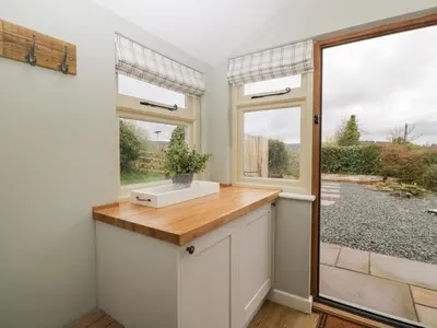 a kitchen with a sink and a window at Pool Cottage in Hereford