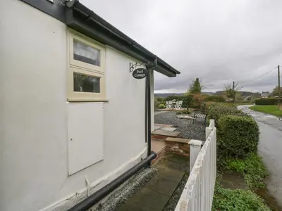 a white house with a white door and a fence at Pool Cottage in Hereford