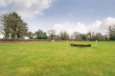 a park with a bench in the middle of a field at 3 Bed in Talybont-on-Usk oc-wal376 in Talybont