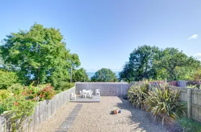 a garden with a fence and a table and chairs at 4 Bed in New Quay oc-was409 in New Quay