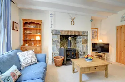 a living room with a blue couch and a fireplace at 4 Bed in New Quay oc-was409 in New Quay