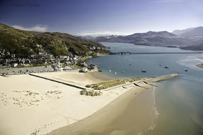an aerial view of a beach with people in the water at 2 Bed in Barmouth oc-wah699 in Talybont