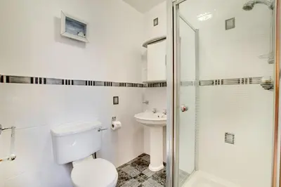 a bathroom with a toilet sink and a shower at 5 Bed in Aberystwyth oc-wan443 in Llanychaiarn