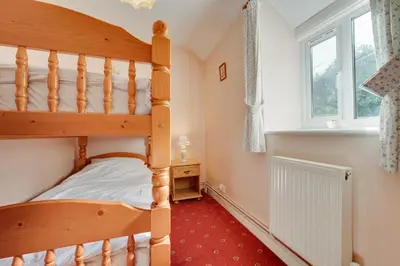 a bedroom with a bunk bed and a window at 2 Bed in Corwen oc-waf161 in Carrog