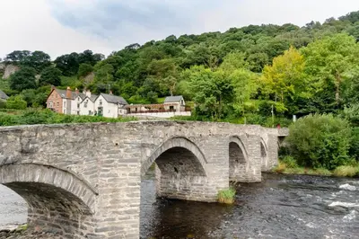 a stone bridge over a river in a village at 2 Bed in Corwen oc-waf161 in Carrog