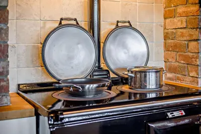 two pots and pans on a stove in a kitchen at 4 Bed in Builth Wells oc-bow197 in Builth Wells