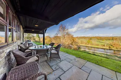 a patio with chairs and tables and a view at 4 Bed in Builth Wells oc-bow197 in Builth Wells