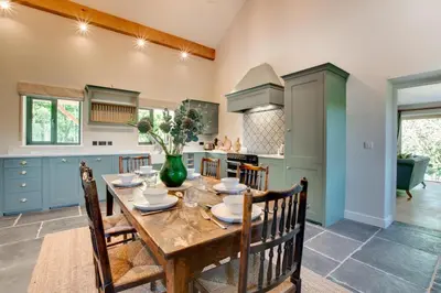 a kitchen with a wooden table and chairs at 2 Bed in Builth Wells oc-bow198 in Builth Wells