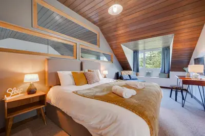 a bedroom with a large bed with a wooden ceiling at 4 Bed in Ffestiniog oc-bow172 in Ffestiniog