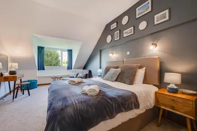 a bedroom with a large bed and a desk at 4 Bed in Ffestiniog oc-bow172 in Ffestiniog