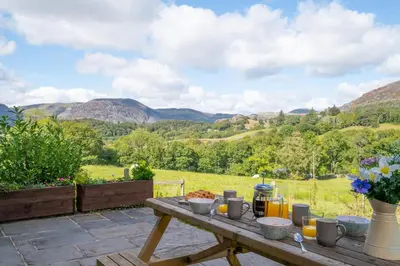 a picnic table with a view of mountains at 4 Bed in Ffestiniog oc-bow172 in Ffestiniog