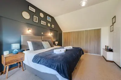 a bedroom with a large bed with two towels on it at 4 Bed in Ffestiniog oc-bow172 in Ffestiniog